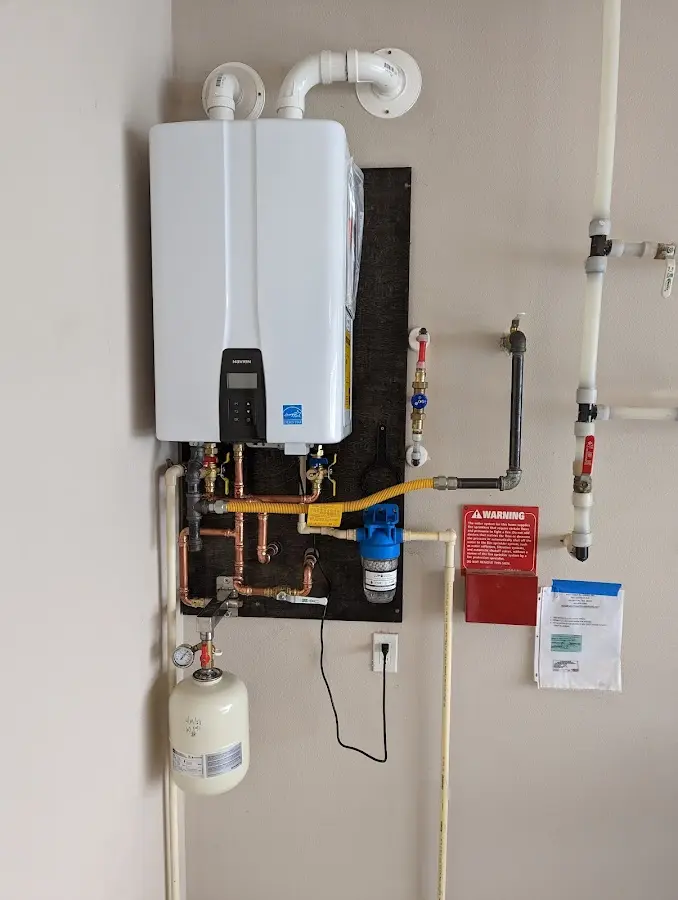 Professional plumber installing copper piping in a Scituate home